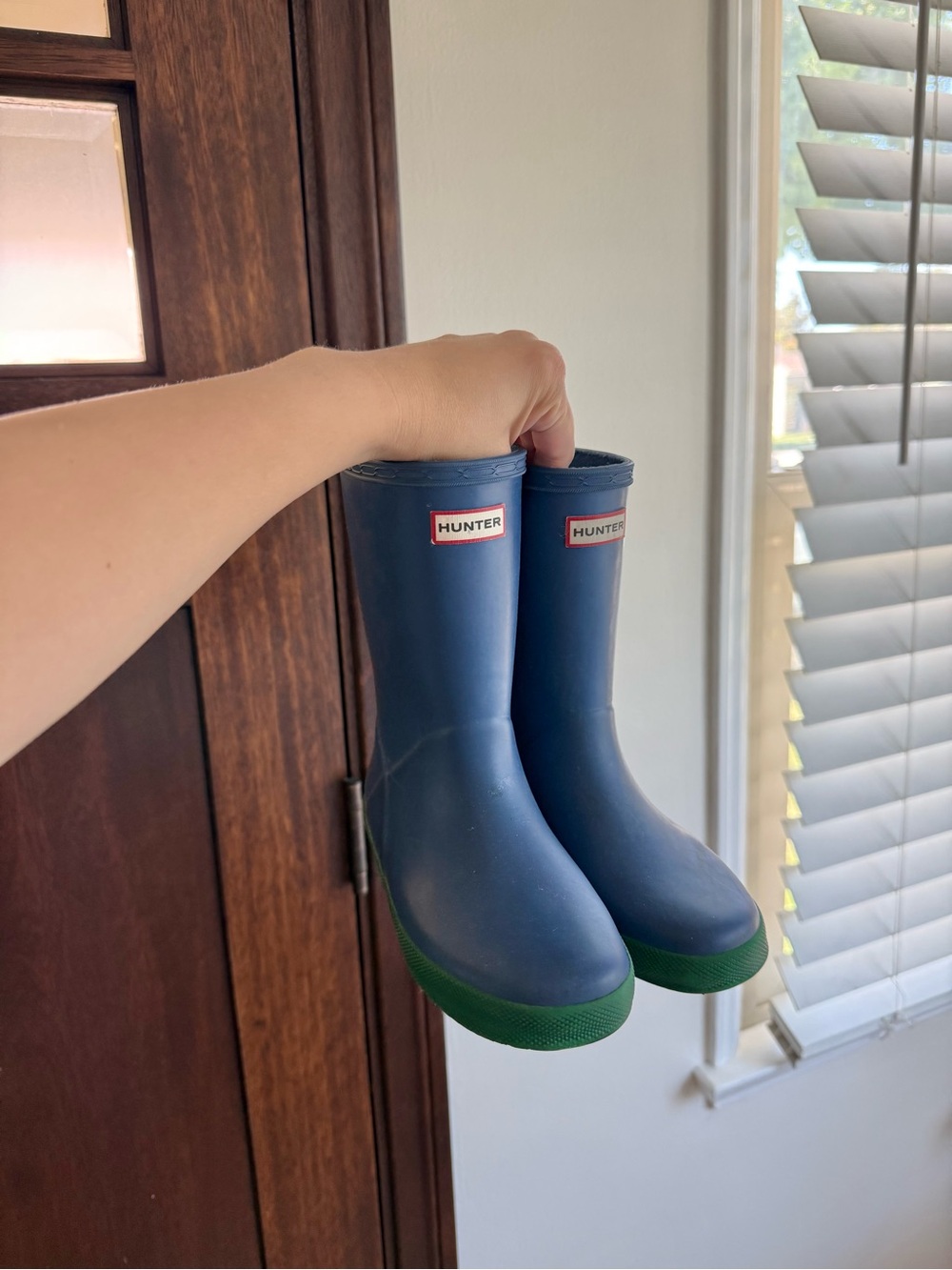 Hunter navy kids rain boots with green soles